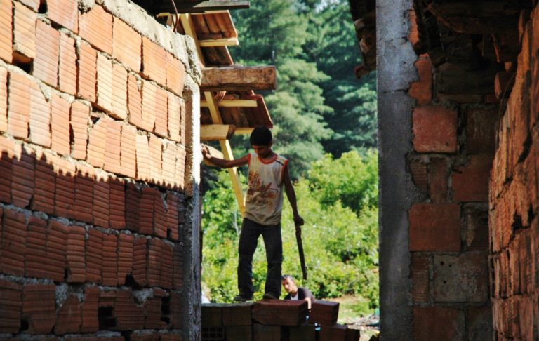 A young man working on a building construction site